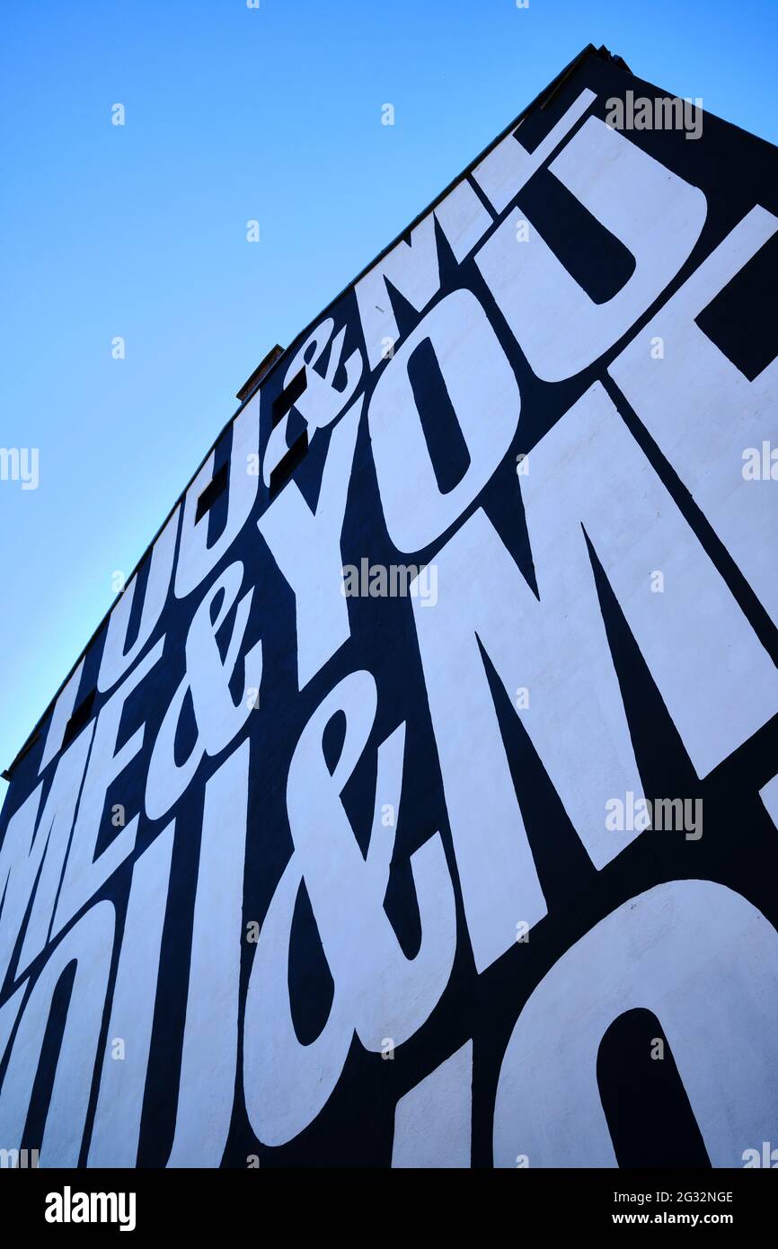 Painted art mural 'You & Me' by Anthony Burrill on the external wall of a warehouse next to Calls Landing in The Calls area of Leeds city centre. Stock Photo