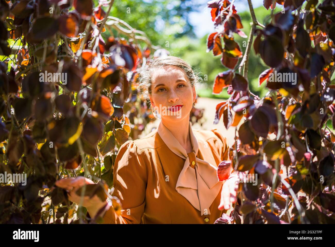 Young Woman in 1940s Fashion in the  Park Stock Photo