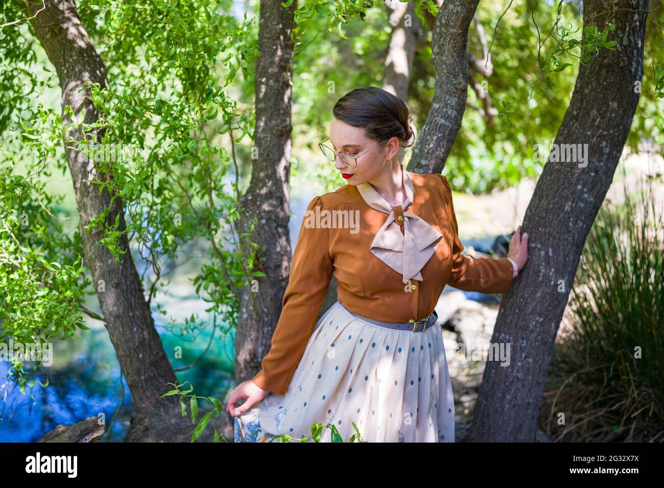 Young Woman in 1940s Fashion in the  Park Stock Photo