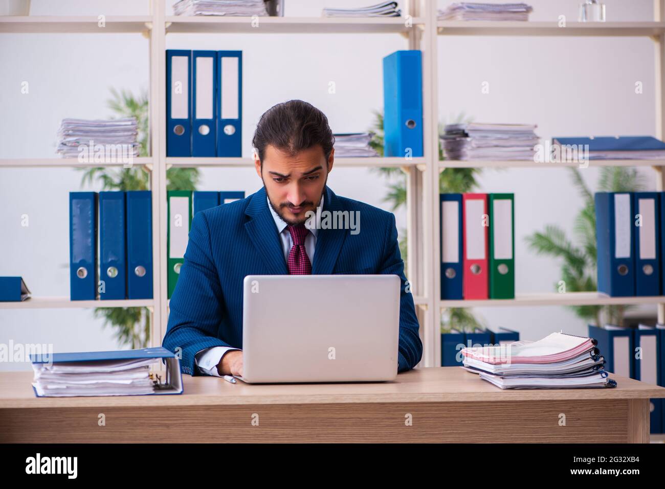 Young employee and too many work in the office Stock Photo - Alamy