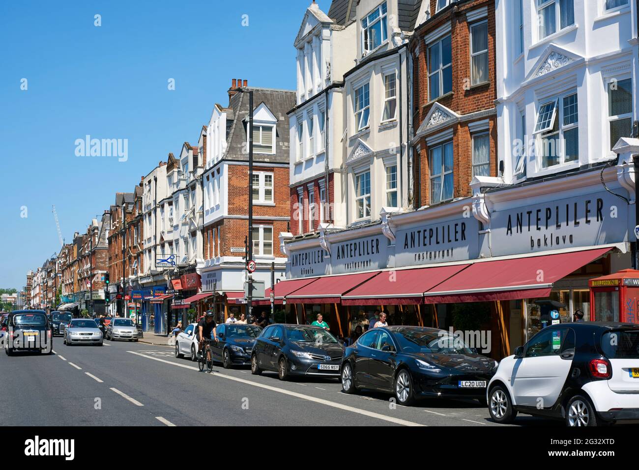 Restaurants, shops and buildings along Green Lanes, Harringay, North London UK, in summertime Stock Photo