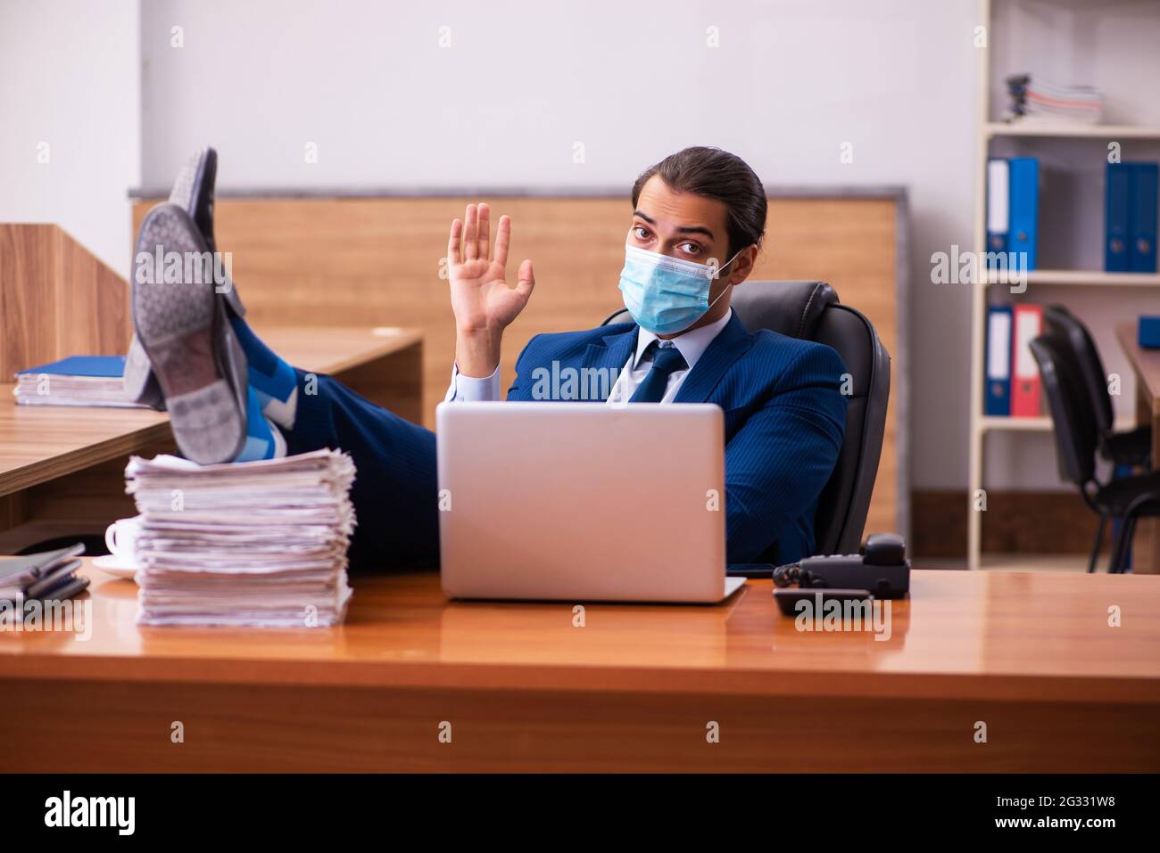 Man wearing mask waving laptop hi-res stock photography and images - Alamy