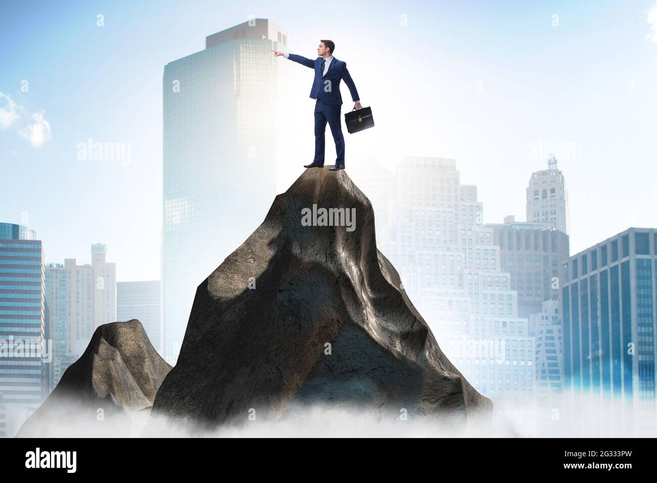 Businessman at the top of mountain in the career concept Stock Photo ...