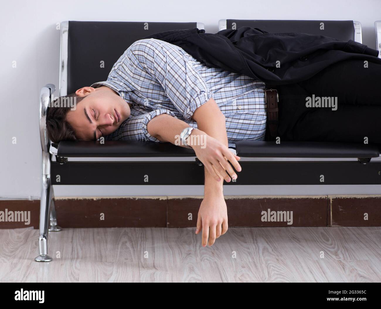 The man sleeping on the chairs in airport Stock Photo Alamy