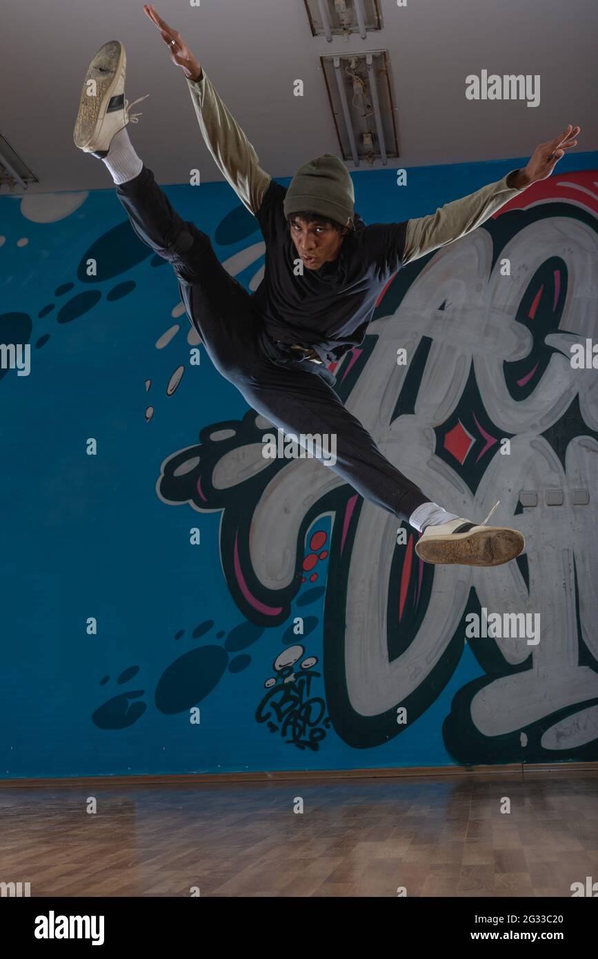 Modern rapper dancing in garage. Urban lifestyle, hip hop Stock Photo ...