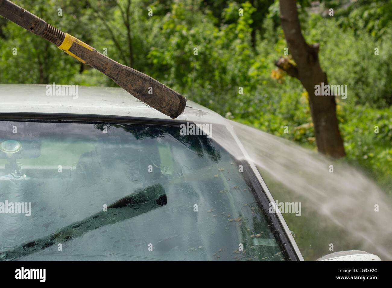 Washing the windshield from dirt. The car is washed by the pressure of