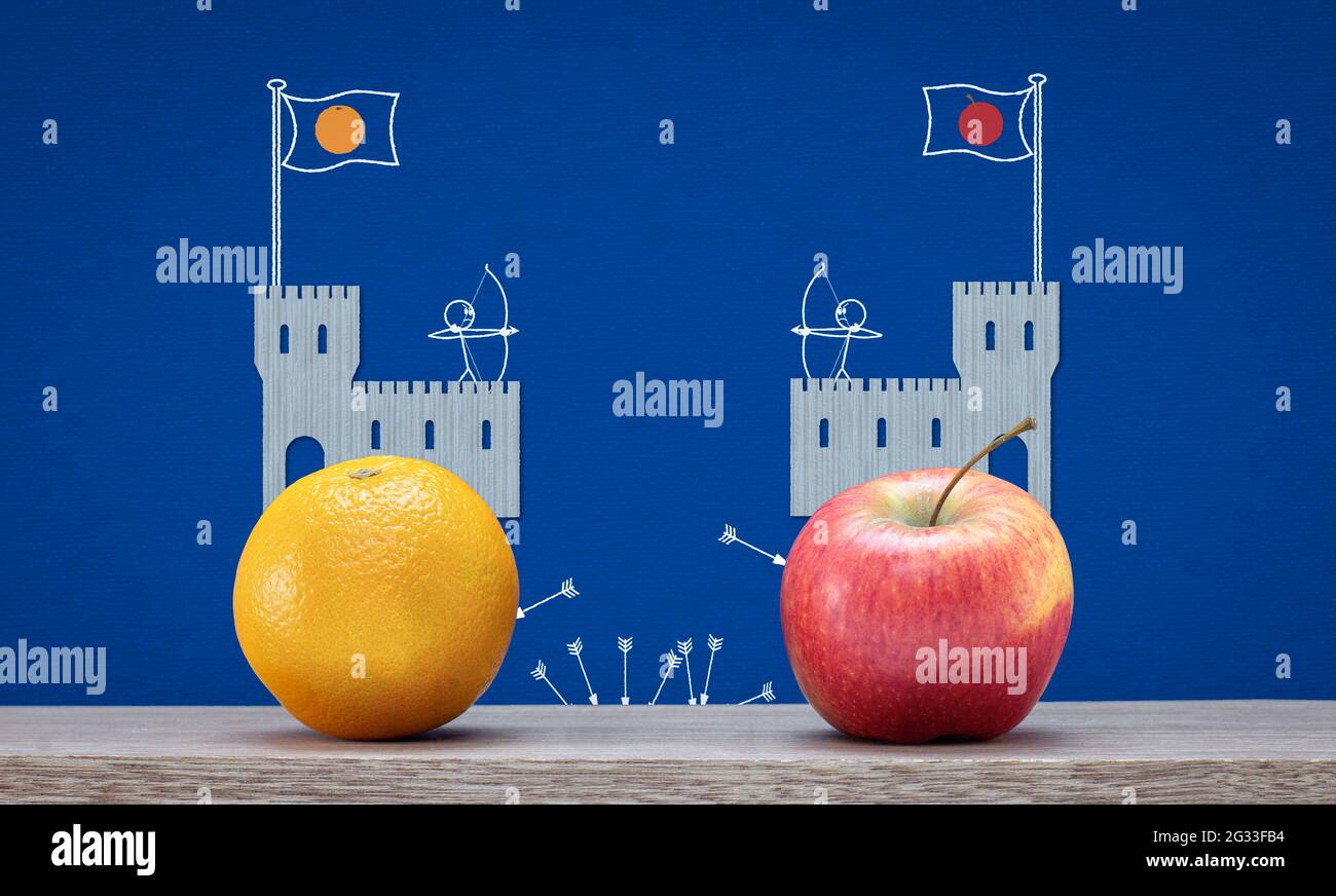 social and political polarisation, tribalism, division concept, apple and orange ideology at castles fighting, illustration on photograph Stock Photo