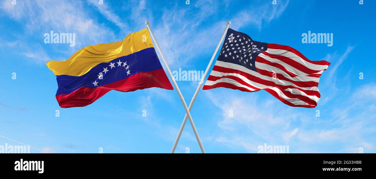 Flags Of Usa And Venezuela Waving In The Wind On Flagpoles Against The 