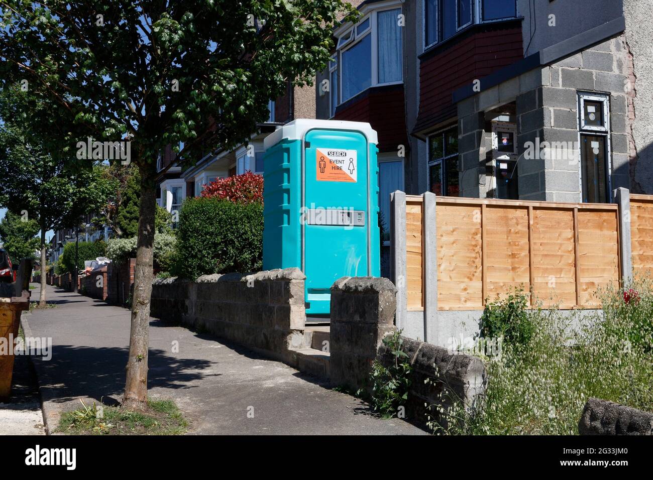 portableble toilet cabin in garden of house during building works Stock Photo