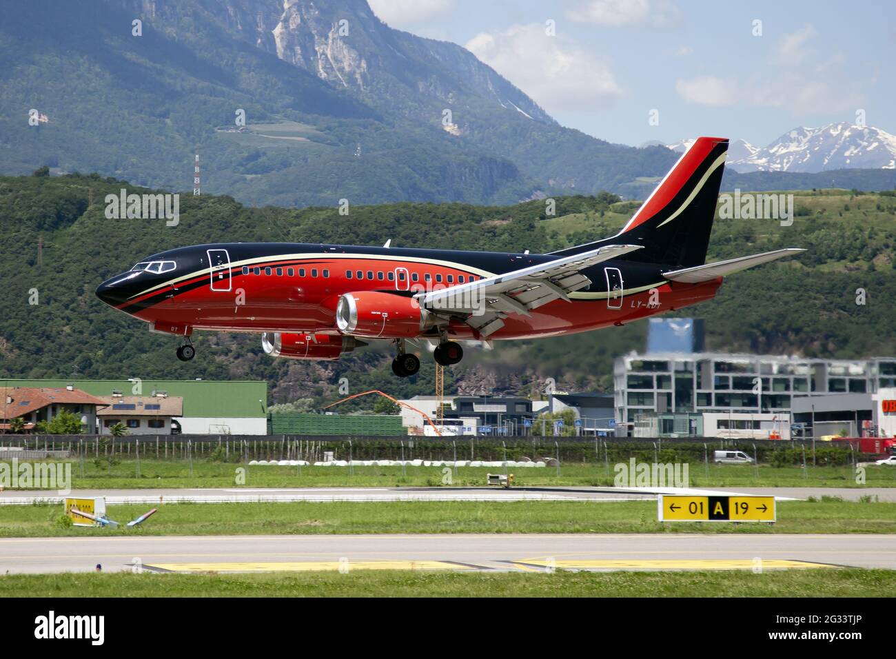 The lituanian Klasjet Boeing 737-500 landing at Bolzano airport carrying the Czech national football team. This is the very first landing of a Boeihg 737 in this regional airport. Stock Photo