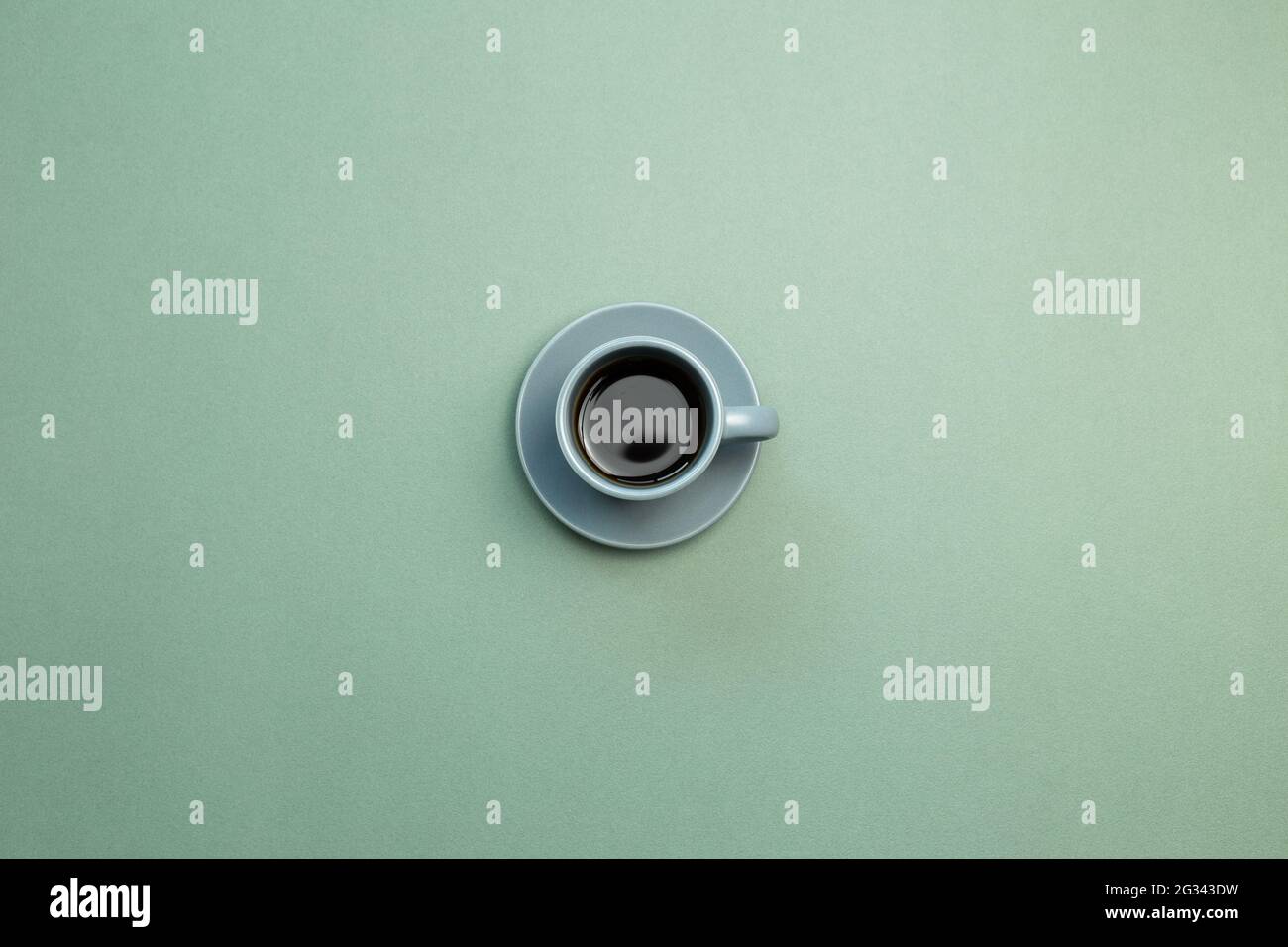 Cup of coffee on green background. top view, copy space Stock Photo