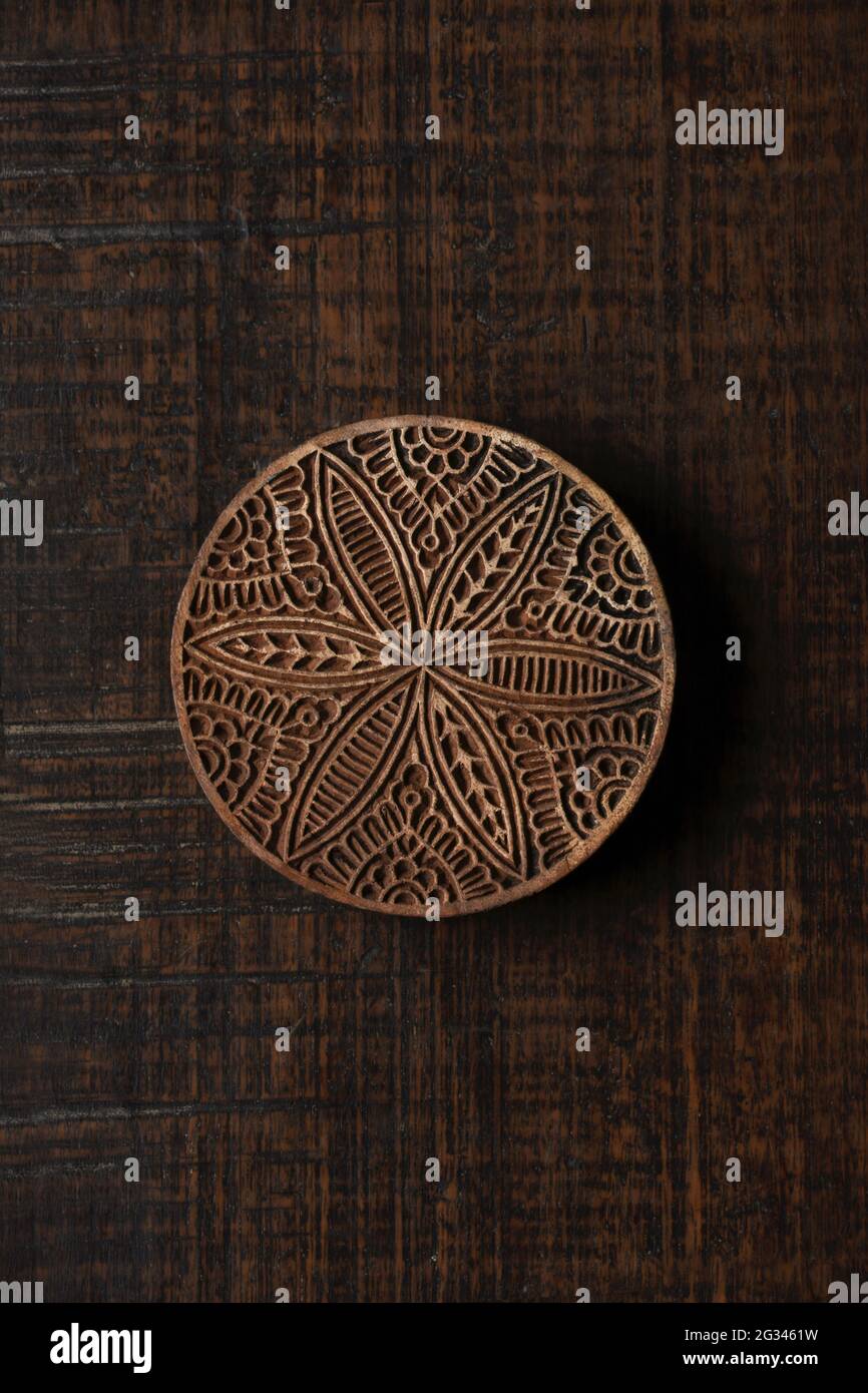 Round shape traditional Indian wood block pattern for textile printing on rustic wood background