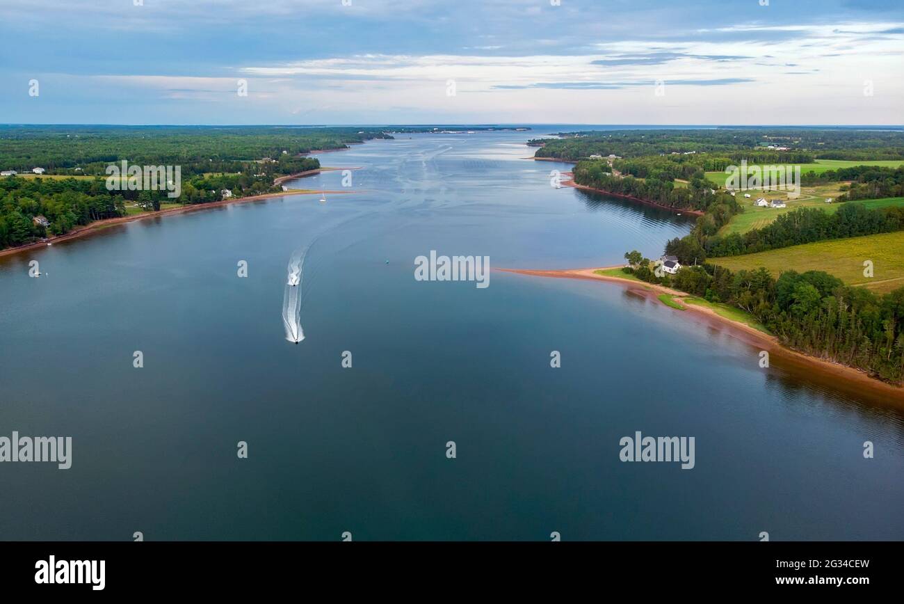 Some boats make their way down the Montague River in Prince Edward Island, Canada Stock Photo