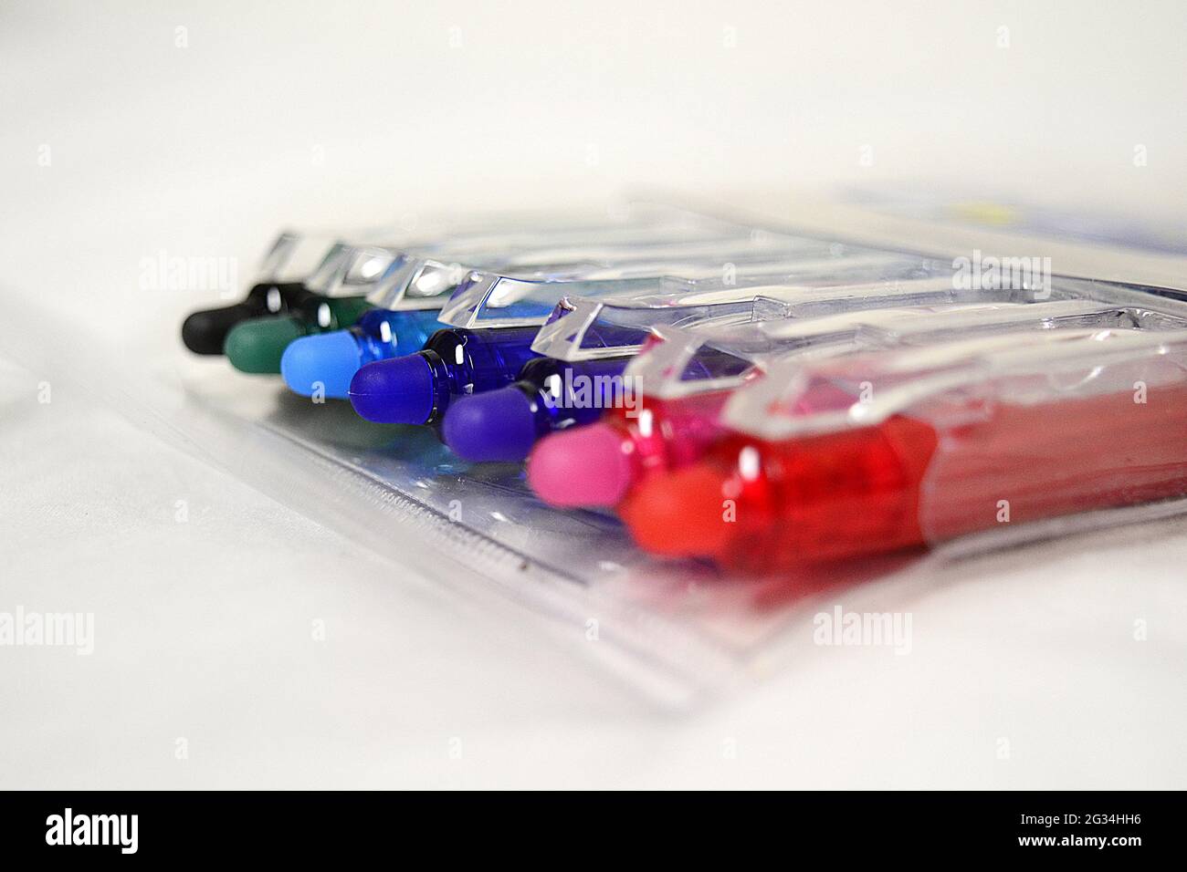 Closeup of the colorful pens in the plastic container on the white ...