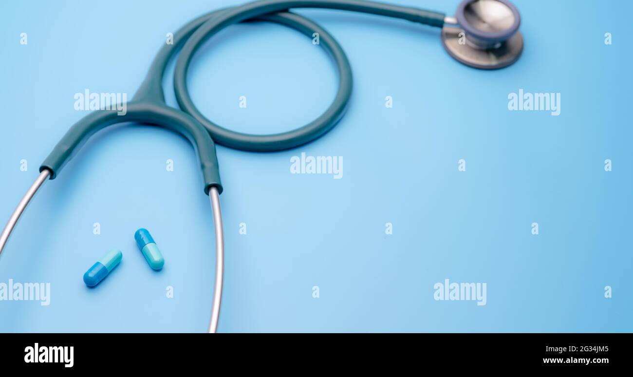 Blue capsule pills and green stethoscope on blue background. Health  checkup. Cardiology doctor equipment for heartbeat test. Healthcare and  medical Stock Photo - Alamy