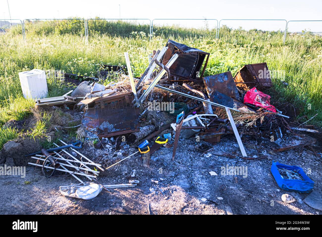 Waste dumped in the countryside, an illegal social issue, fly tipping is causing environmental pollution. Stock Photo