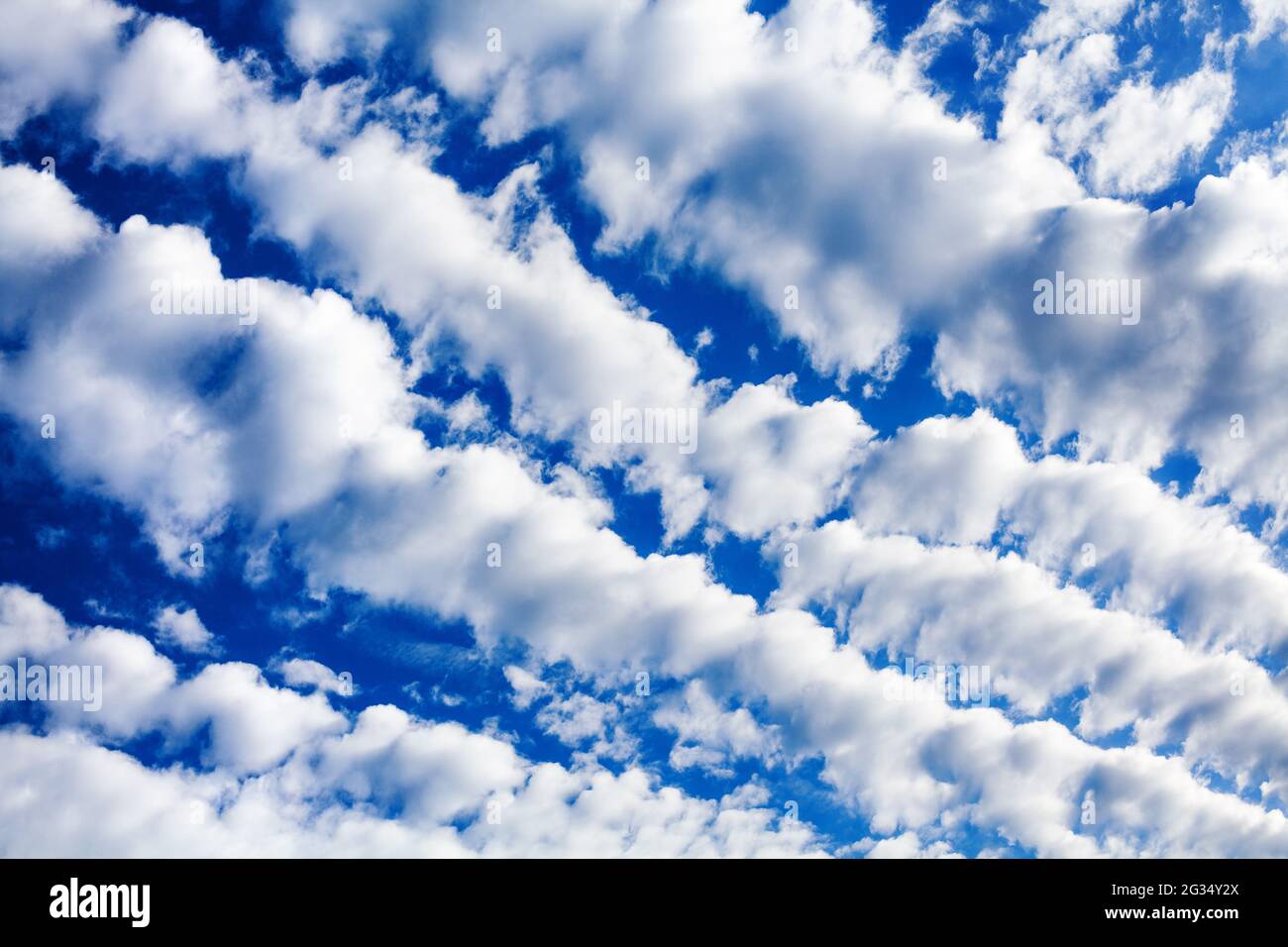 White cirrocumulus clouds blue sky background, fluffy stratocumulus cloud texture, altocumulus cloudy skies, beautiful cirrus cloudscape, cloudiness Stock Photo