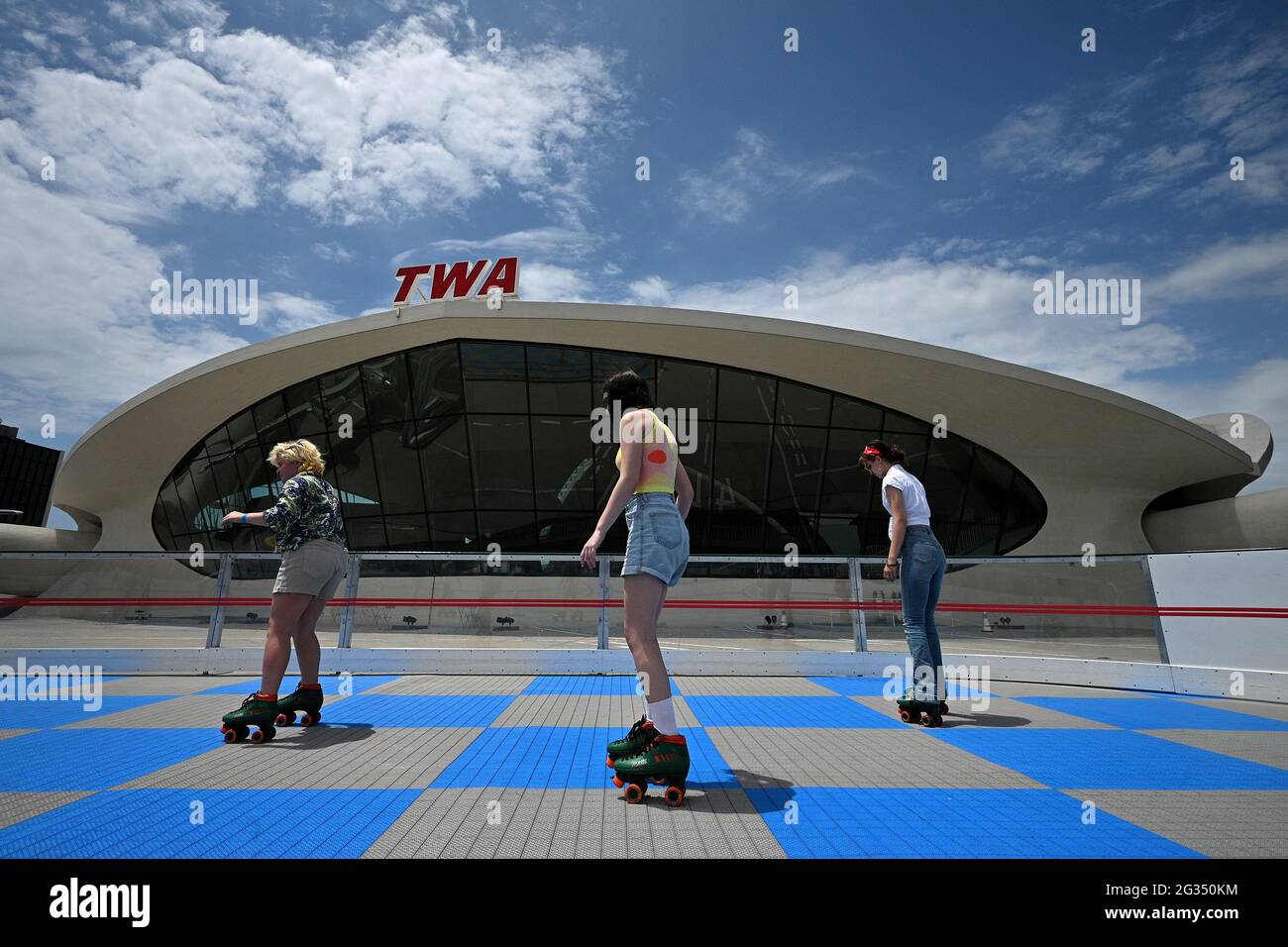 People roller skate at a rink behind the TWA Hotel at JFK International