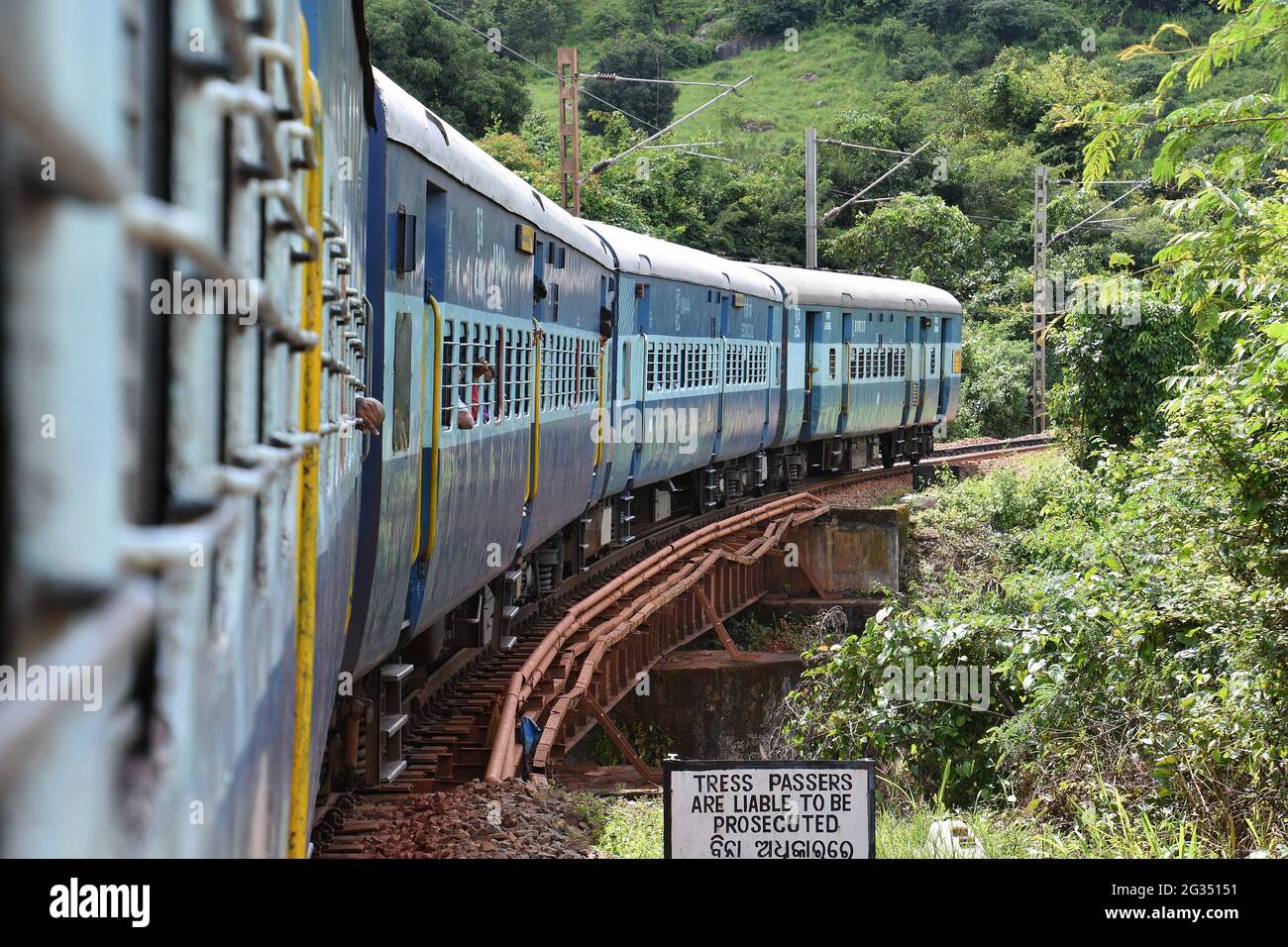 Kirandul Passenger crawls towards Araku on mountainous terrain, Indian Railways Stock Photo