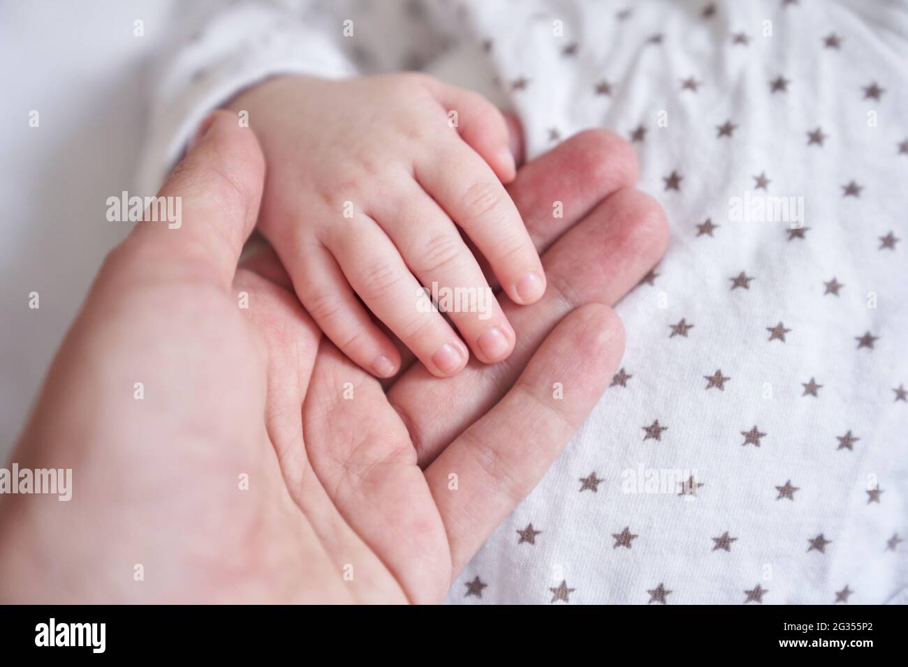Mothers hand holding baby hand. The baby is one month old. Cute little hand  with small fingers. Concept of love and care background. High quality photo  Stock Photo - Alamy