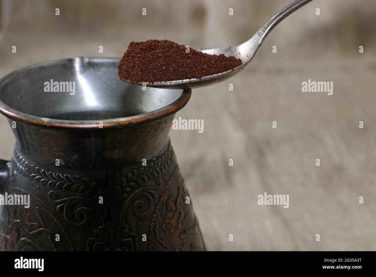 Turkish coffee pot and spoon with ground coffee. Selective fokus. Stock Photo