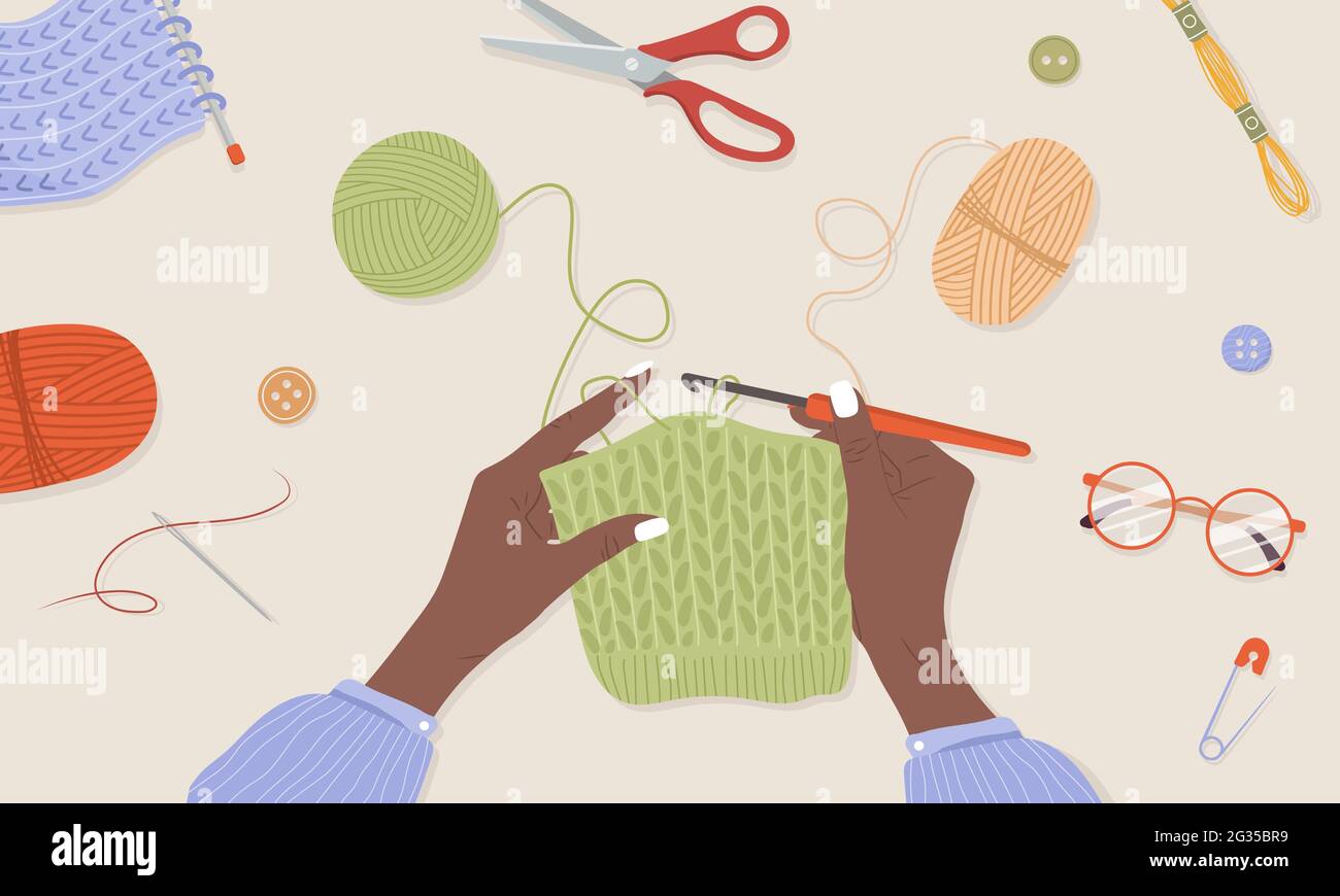 Crochet knitting process. African female hands with hook and thread