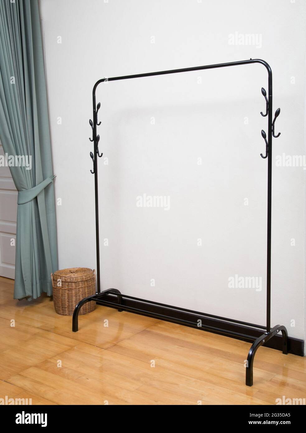 Empty black cloths rack in white room interior background Stock Photo
