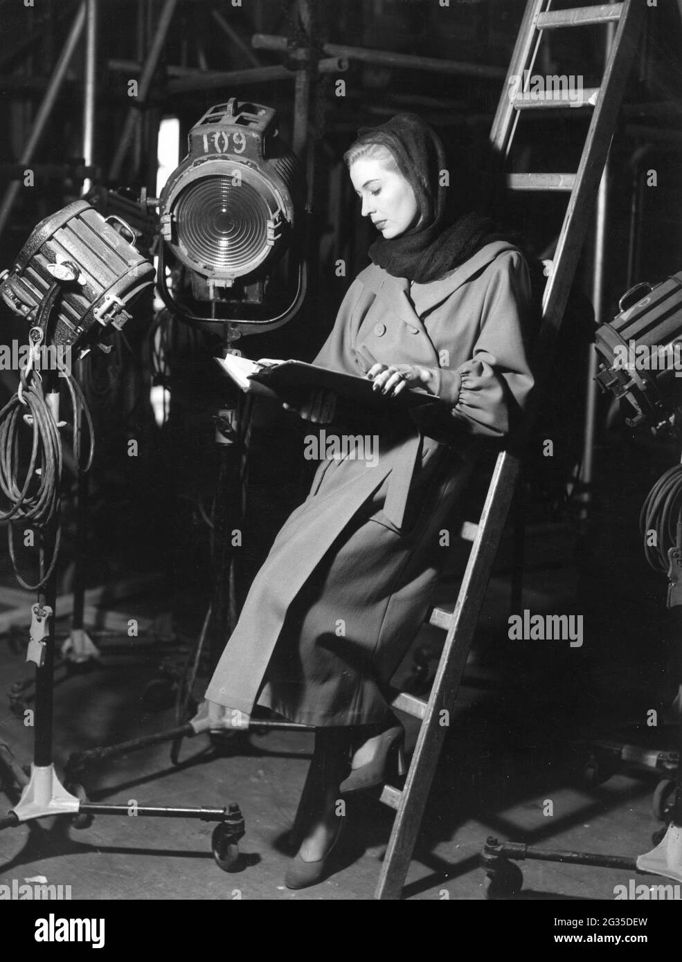 VALERIE HOBSON on set candid checking her script at Denham Studios during filming of THE ROCKING HORSE WINNER 1949 director / screenplay ANTHONY PELISSIER from short story by D.H. Lawrence wardrobe designed by Victor Stiebel producer John Mills Two Cities Films / John Mills productions / J. Arthur Rank Organisation / General Film Distributors (GFD) Stock Photo