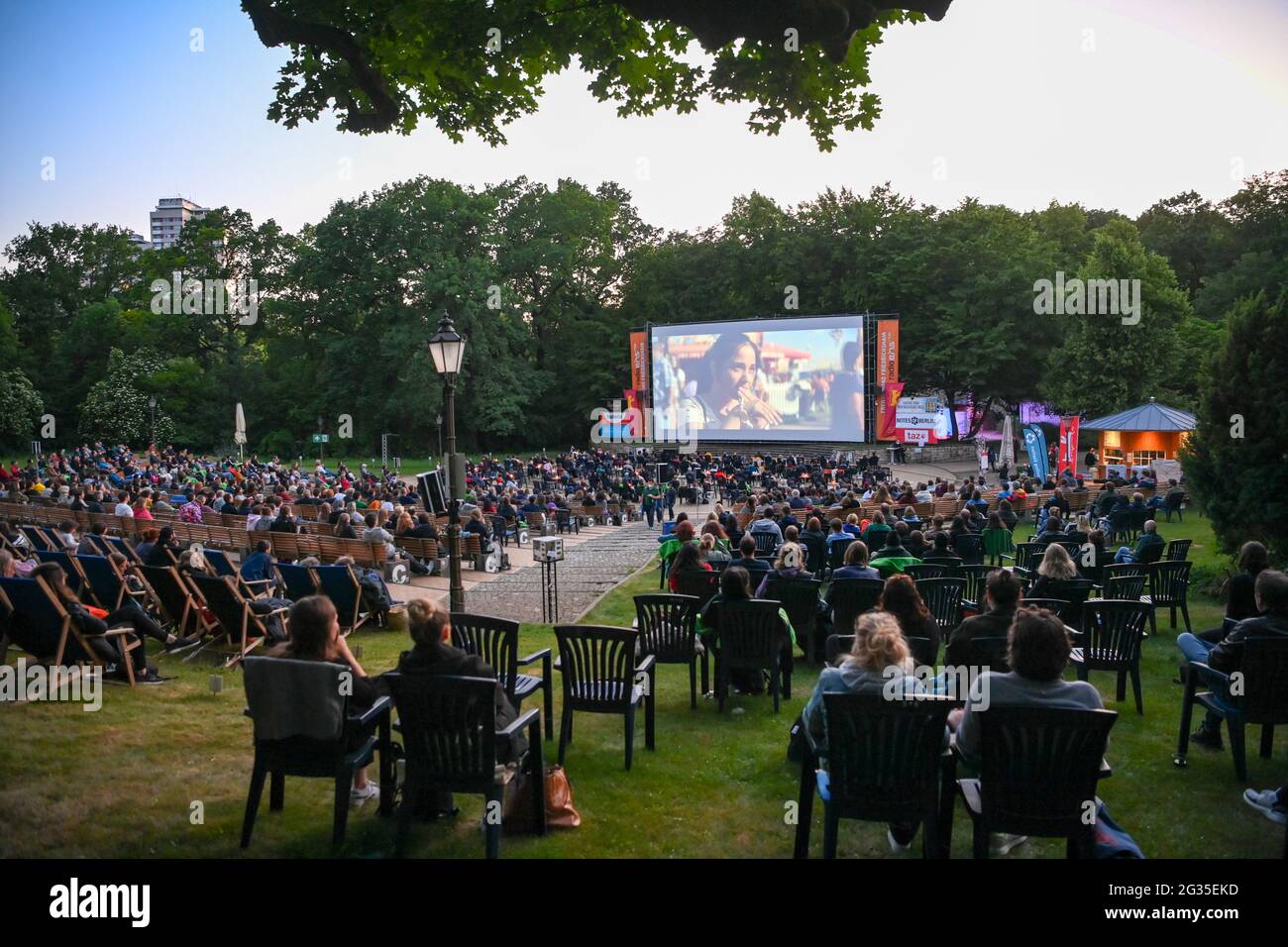 Berlin, Germany. 13th June, 2021. Numerous audience members sit during a late-night screening at the Friedrichshain open-air cinema during the premiere of 'The World Will Be a Different Place' of the Panorama section at the 71st International Film Festival. Following a digital format in March, the Berlinale opens its summer festival to the public. Credit: Jens Kalaene/dpa-Zentralbidl/dpa/Alamy Live News Stock Photo
