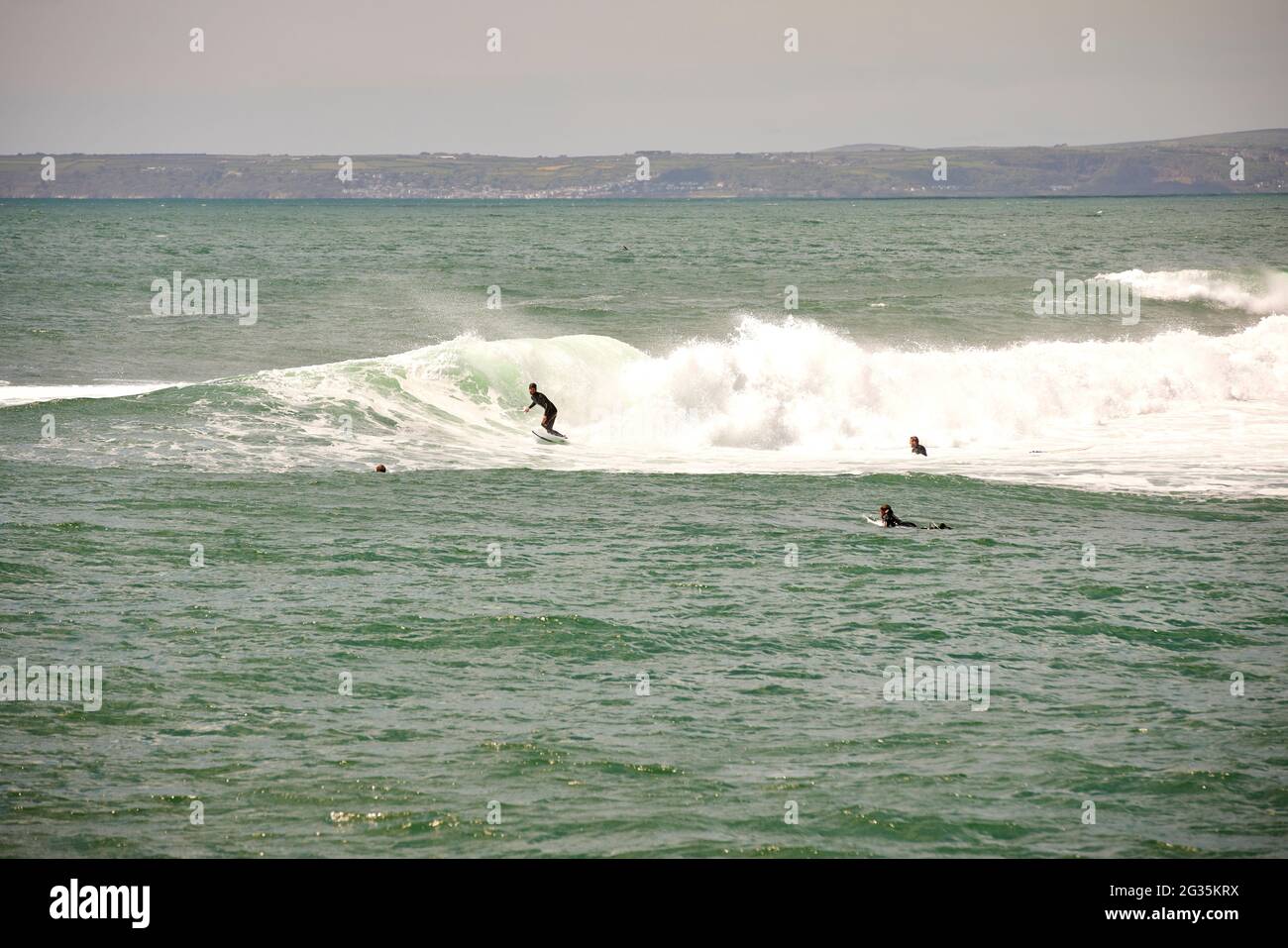 Cornish tourist destination Porthleven, Cornwall, England,  pictured surfers on the coast riding waves Stock Photo