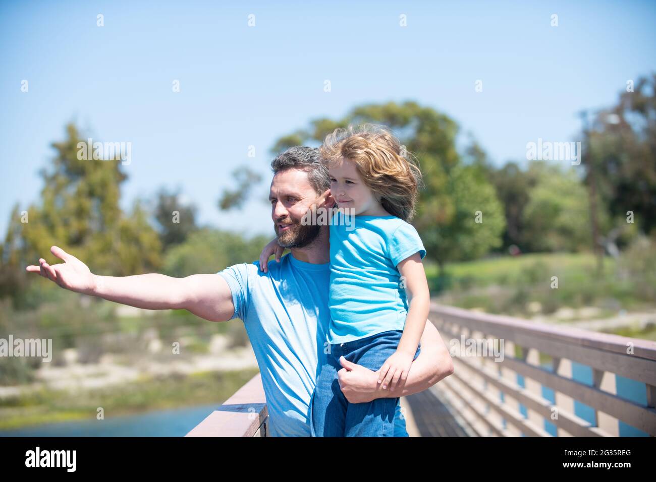 Its really wonderful, parenting. Happy father point finger holding son in arms. Single parenting Stock Photo