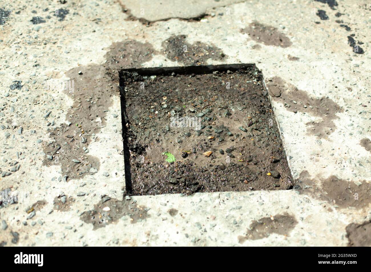 Road repair. Removing holes in the road. A cut piece of asphalt