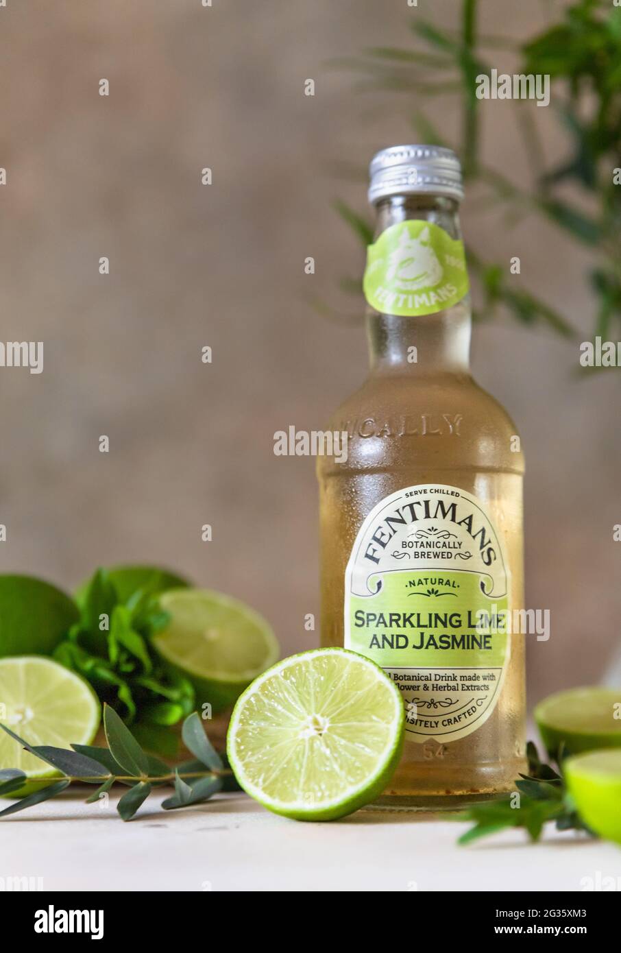 Kaliningrad, Russia - May, 2021 - Bottle of Fentimans lime and jasmine lemonade. Carbonated non-alcoholic drink with lime on light concrete background Stock Photo