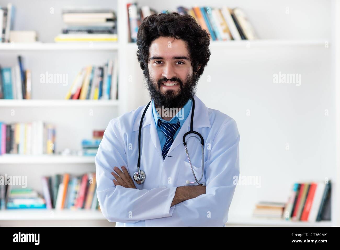 Laughing pakistani male doctor or medical scientist at hospital Stock