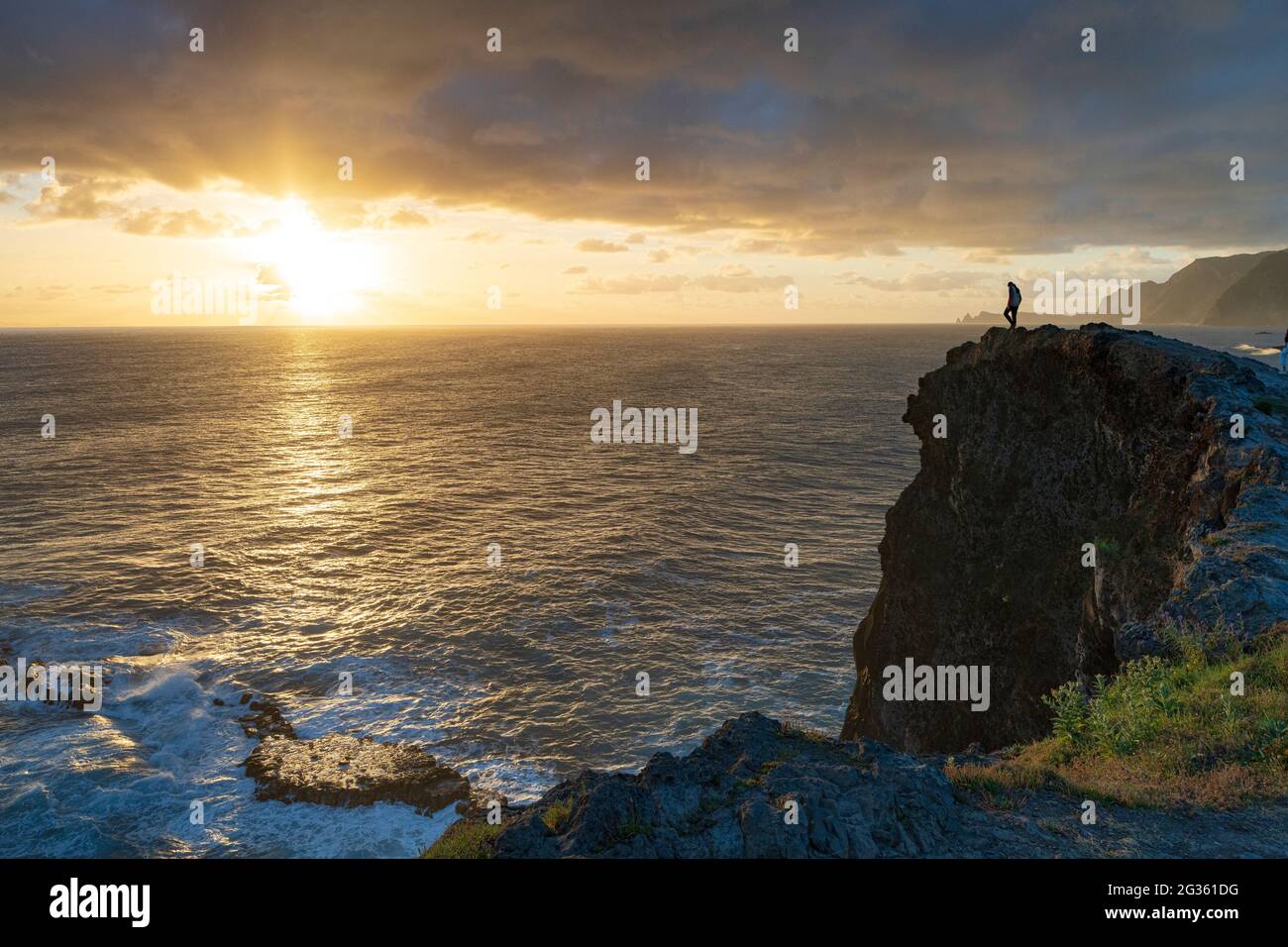 Silhouette of man standing on top of cliffs during sunrise, Madeira island, Portugal Stock Photo