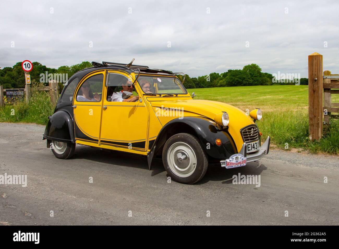 1988 80s eighties yellow Citroen 2Cv6 Dolly 602cc  petrol saloon, travelling to classic and vintage car show at Heskin Hall, Lancashire, UK Stock Photo