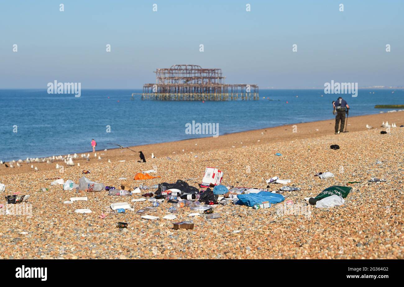 Brighton UK 14th June 2021 - Rubbish left on Brighton beach after a weekend of hot sunshine despite notices asking visitors to take their litter home  : Credit Simon Dack / Alamy Live News Stock Photo