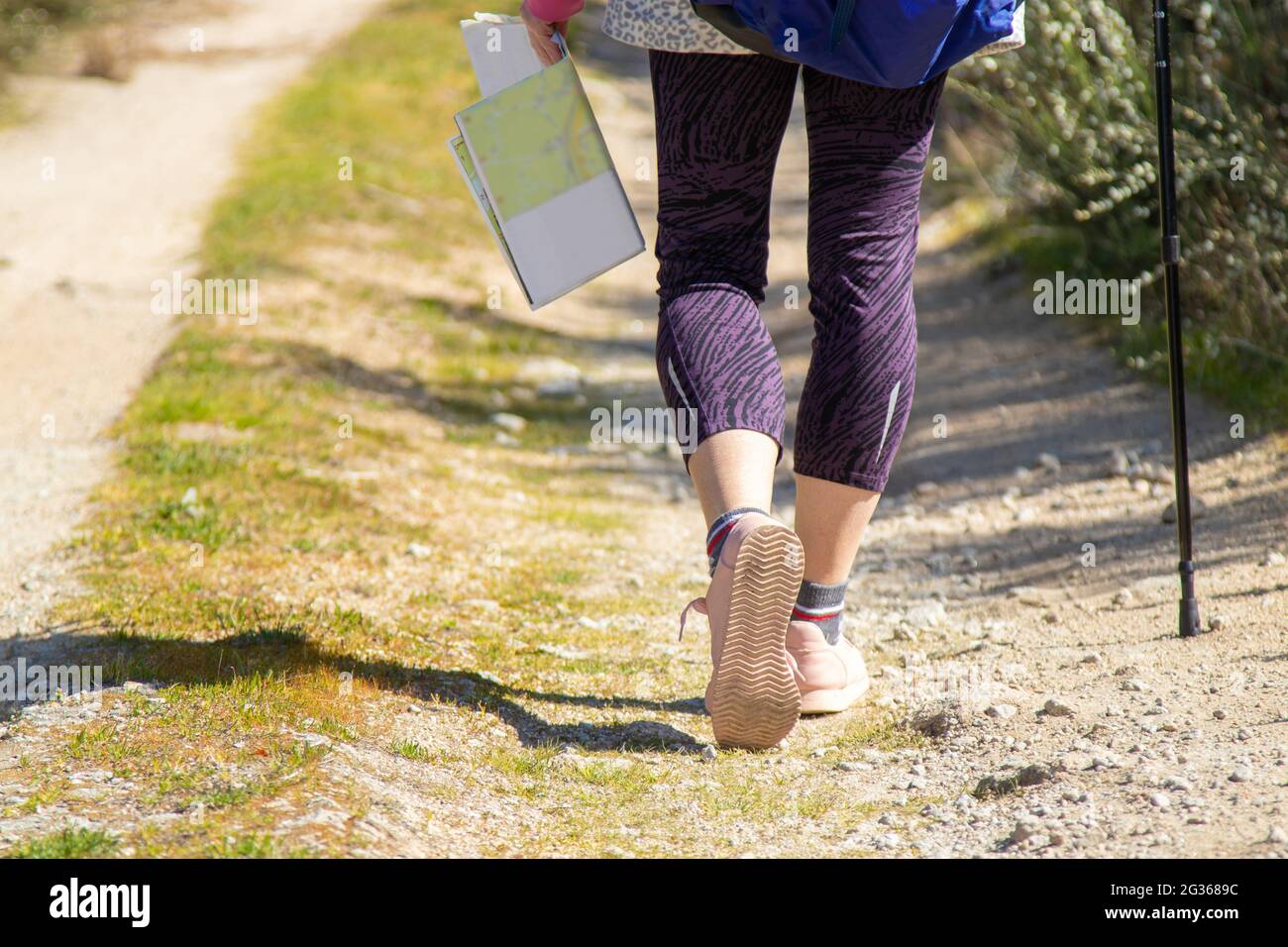 hiker feet on the trail with map and walking stick Stock Photo - Alamy