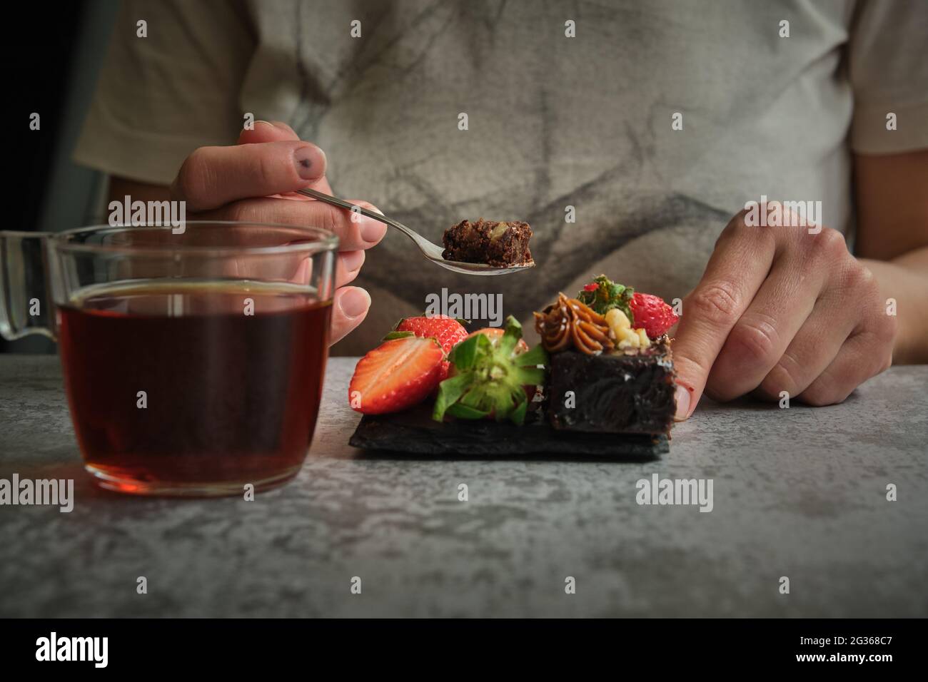 Girl Eats Cake And Drinks Tea Stock Photo Alamy