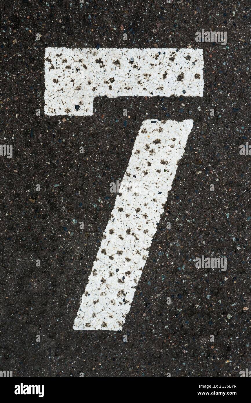 White number 7 painted on tar Stock Photo