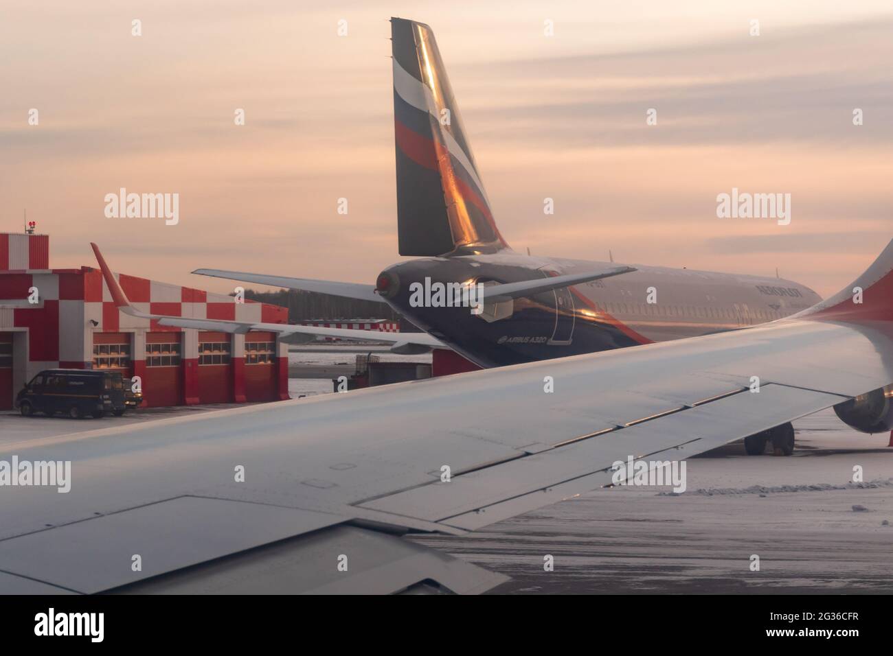 Yekaterinburg. Russia. 12/20/2020. View from the airplane window of the runway and control tower during takeoff at dawn. Ural Airlines. Aeroflot Stock Photo