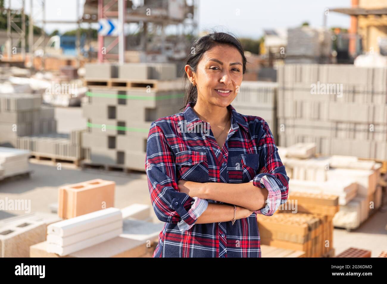 Woman worker posing at building materials warehouse Stock Photo