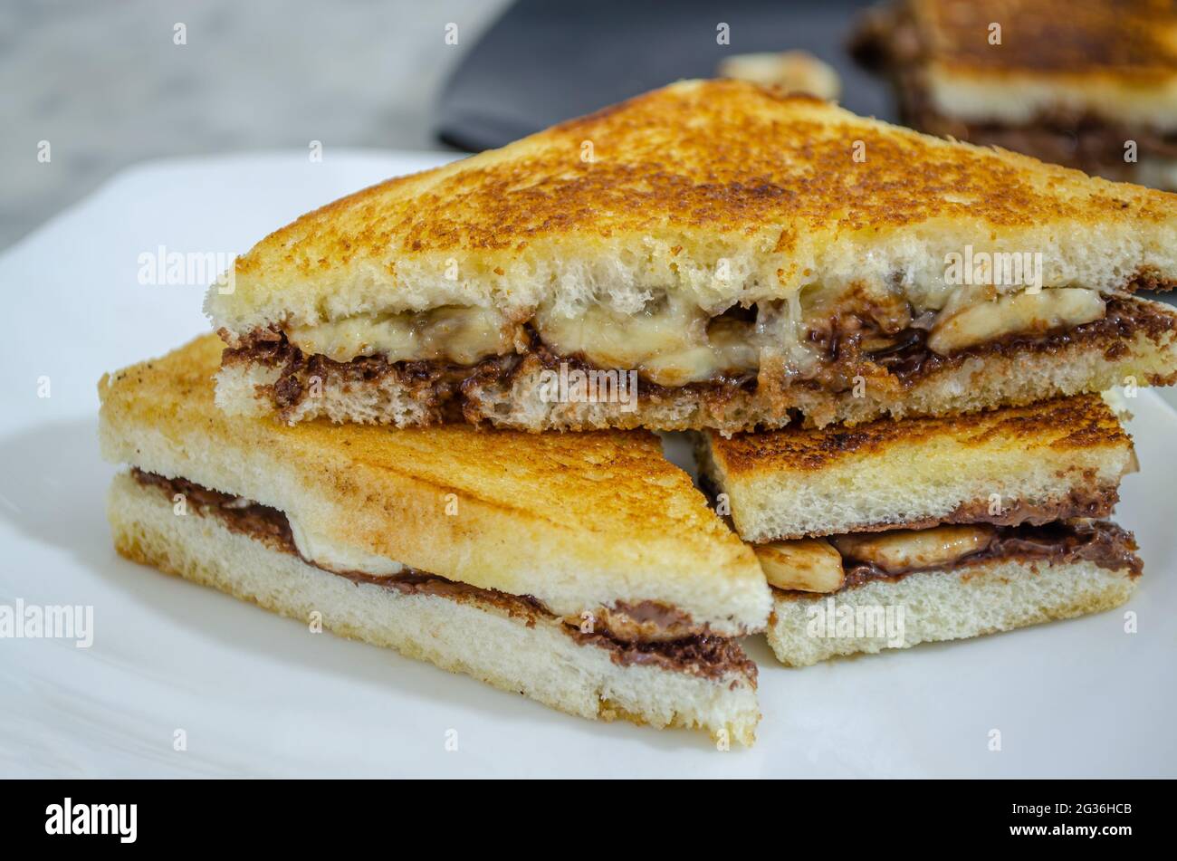 Ready-to-Eat, Yummy, Chocolate Banana Sandwich pieces in a plate. Macro Shot Stock Photo