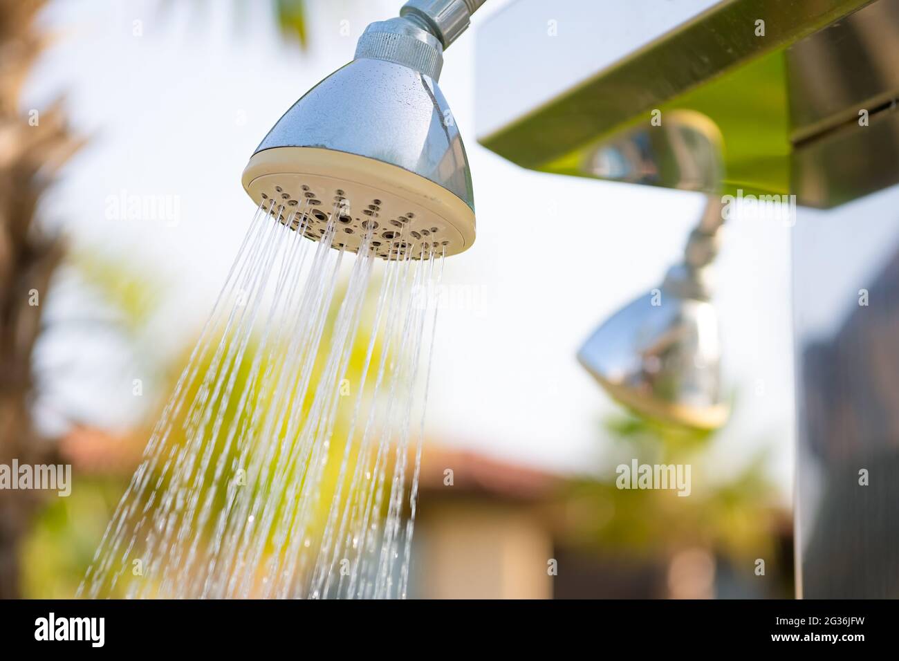 Outdoor refreshing shower head spraying water to take shower before