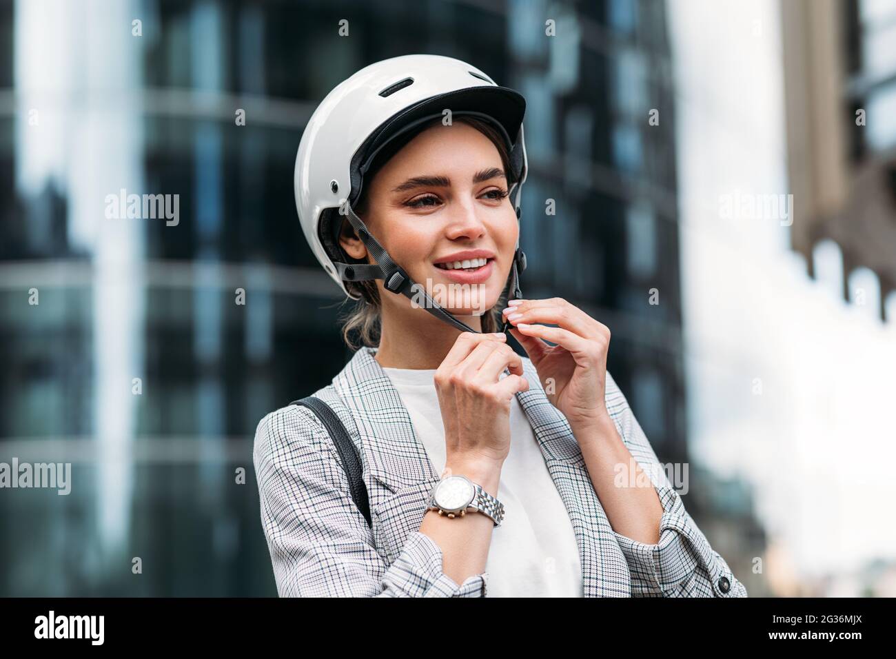 Young woman putting on helmet hi-res stock photography and images - Alamy