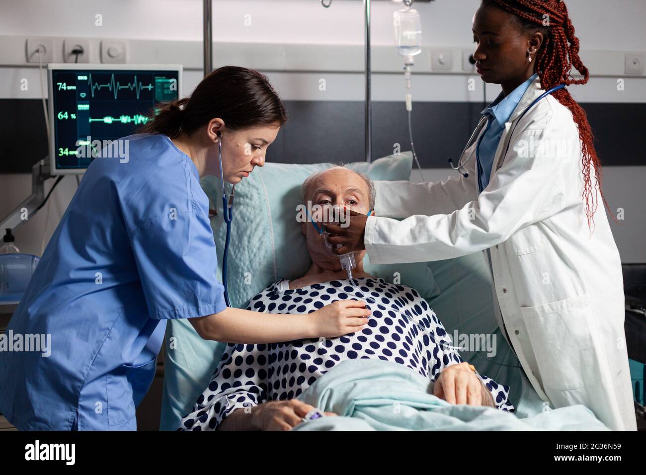 African Doctor And Medical Assistant Helping Senior Man Breath Using Oxygen Mask In Hospital 