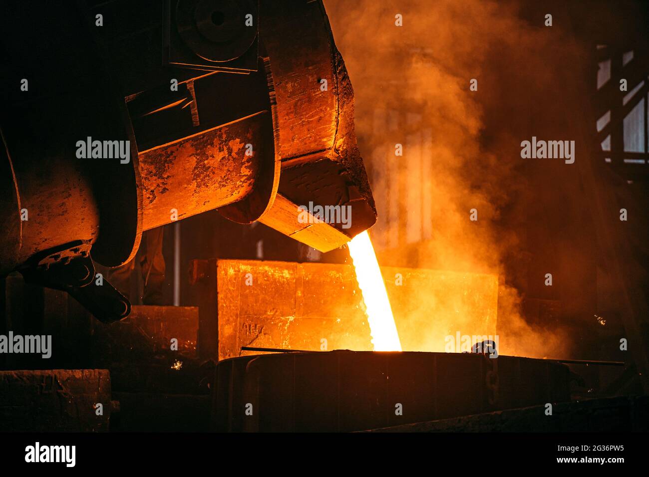 Foundry. Metal Cast Process. Molten Iron pouring with sparks and smoke