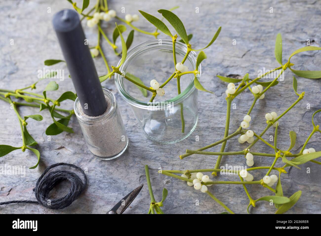 candle with mistletoe as a table decoration Stock Photo