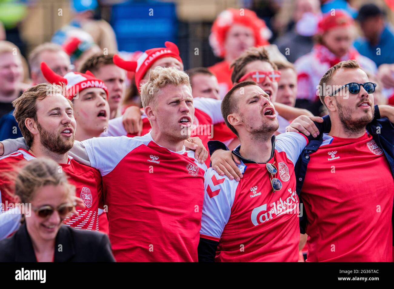 Copenhagen, Denmark. 12th June, 2021. Danish football fans dressed with fan  gear in red and white warm up for the UEFA EURO 2020 match between Denmark  and Finland in Copenhagen. (NB: The