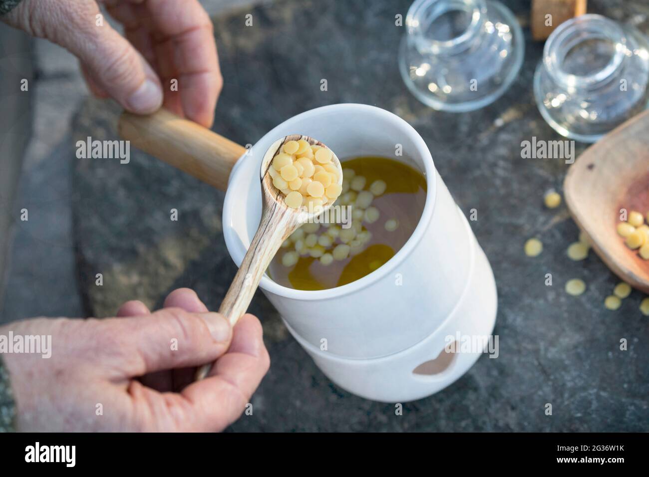 make resin ointment yourself, spruce resin is stirred together with olive oil and beeswax to form a healing ointment Stock Photo